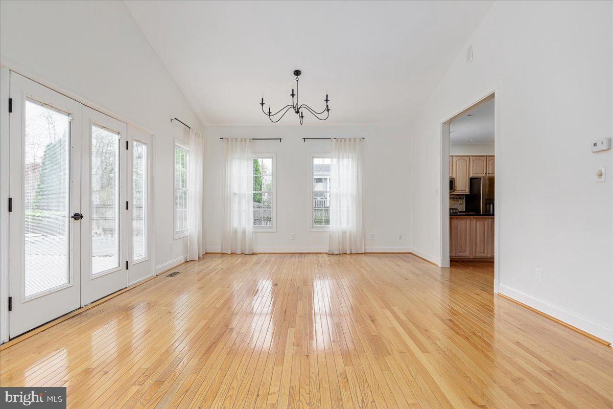 8747 Diamond Hill Drive Bristow, VA 20136 - Photo 12 of 38 a view of an empty room with wooden floor and a window