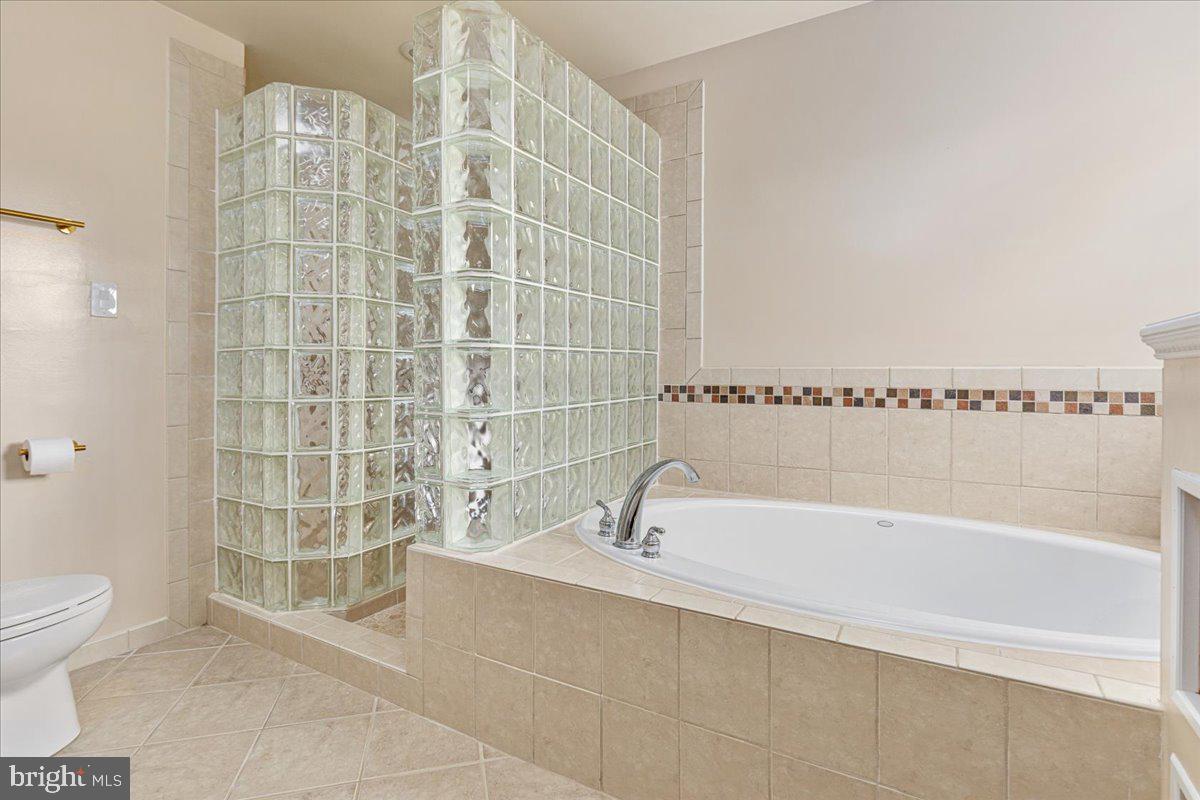 8747 Diamond Hill Drive Bristow, VA 20136 - Photo 22 of 38 a bathroom with a bathtub and a shower