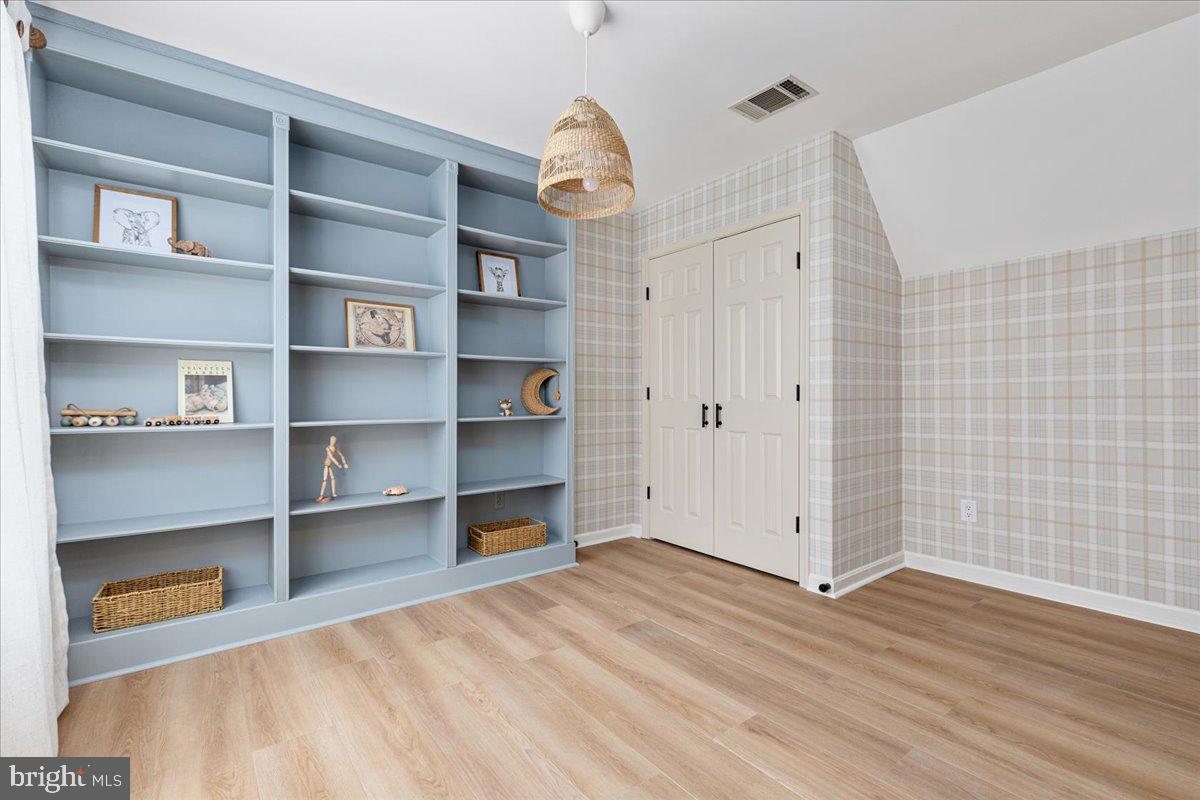 8747 Diamond Hill Drive Bristow, VA 20136 - Photo 24 of 38 a view of empty room with wooden floor and cabinet