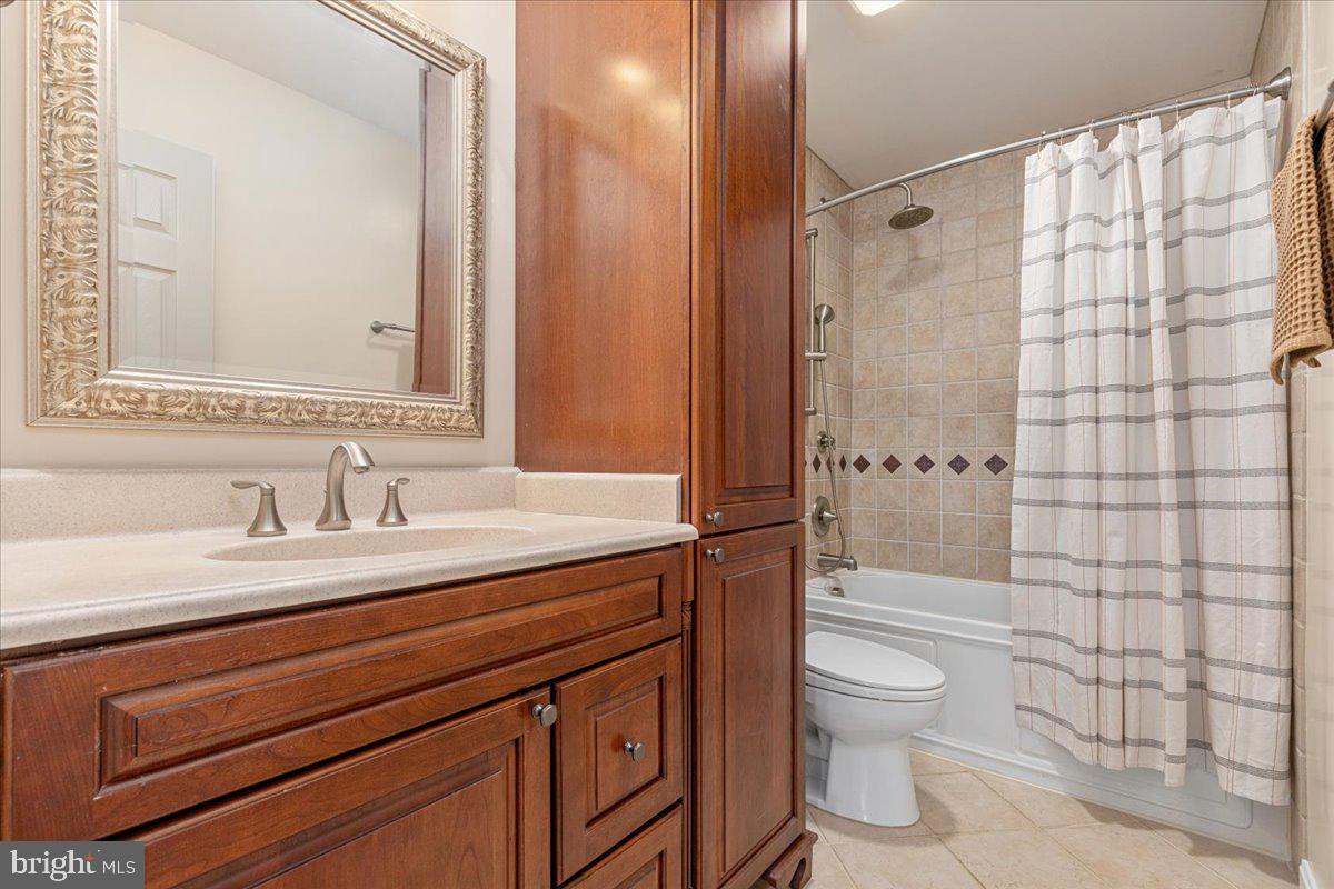 8747 Diamond Hill Drive Bristow, VA 20136 - Photo 27 of 38 a bathroom with a granite countertop sink toilet a mirror a vanity and shower