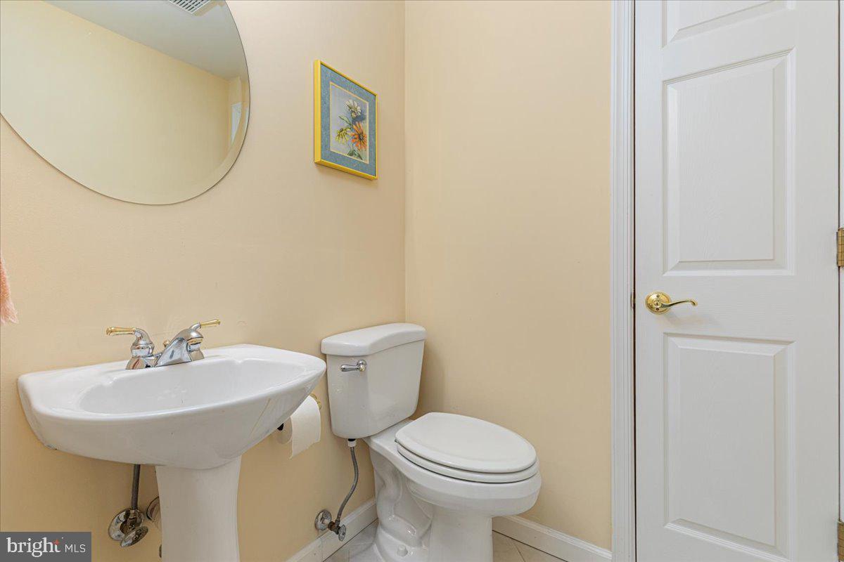 8747 Diamond Hill Drive Bristow, VA 20136 - Photo 31 of 38 a bathroom with a sink mirror and toilet