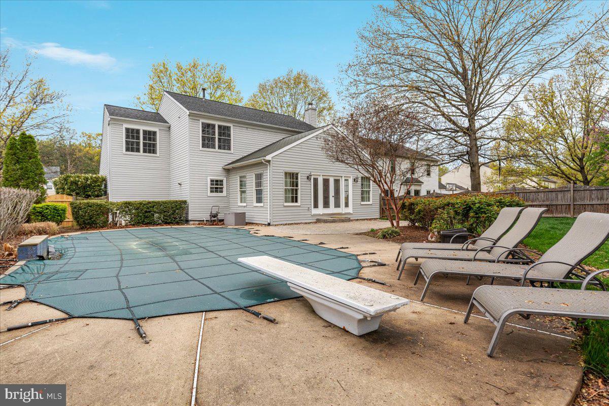 8747 Diamond Hill Drive Bristow, VA 20136 - Photo 34 of 38 a view of a white house with a yard chairs and couches