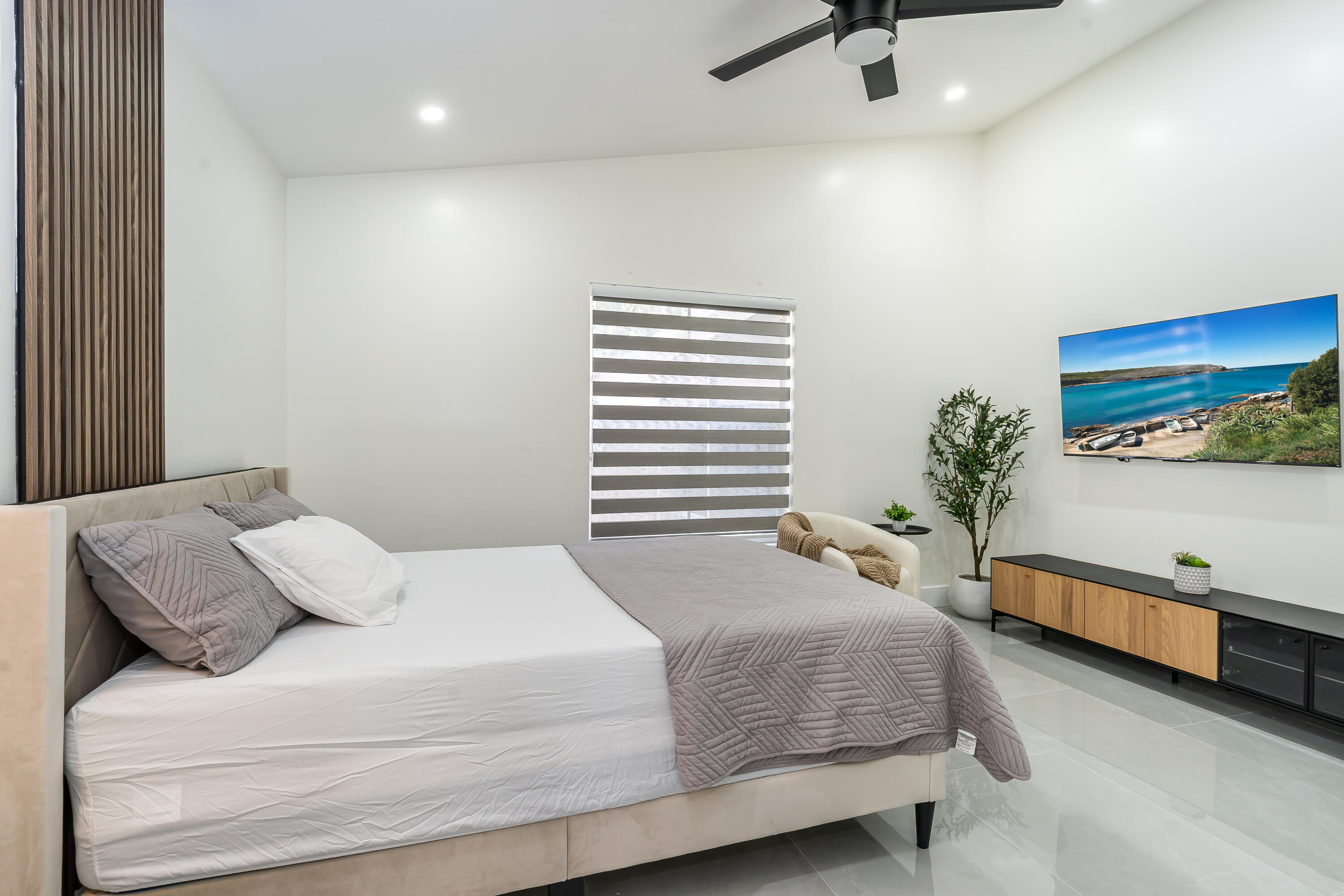 3084 Lighthouse Place Margate, FL 33063 - Photo 16 of 41 a bedroom with a bed and a potted plant on the dresser