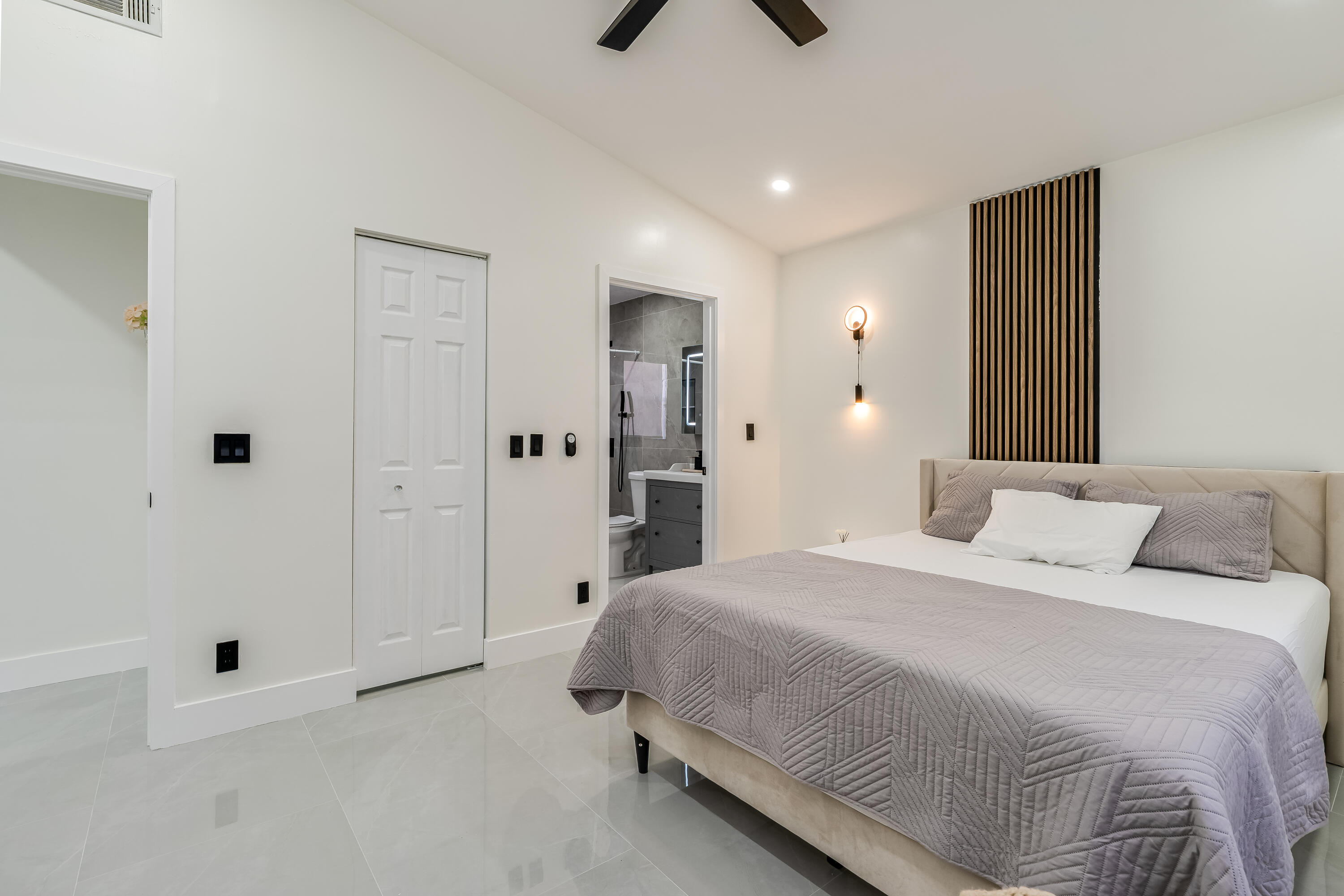 3084 Lighthouse Place Margate, FL 33063 - Photo 18 of 41 a spacious bedroom with a bed and a chandelier