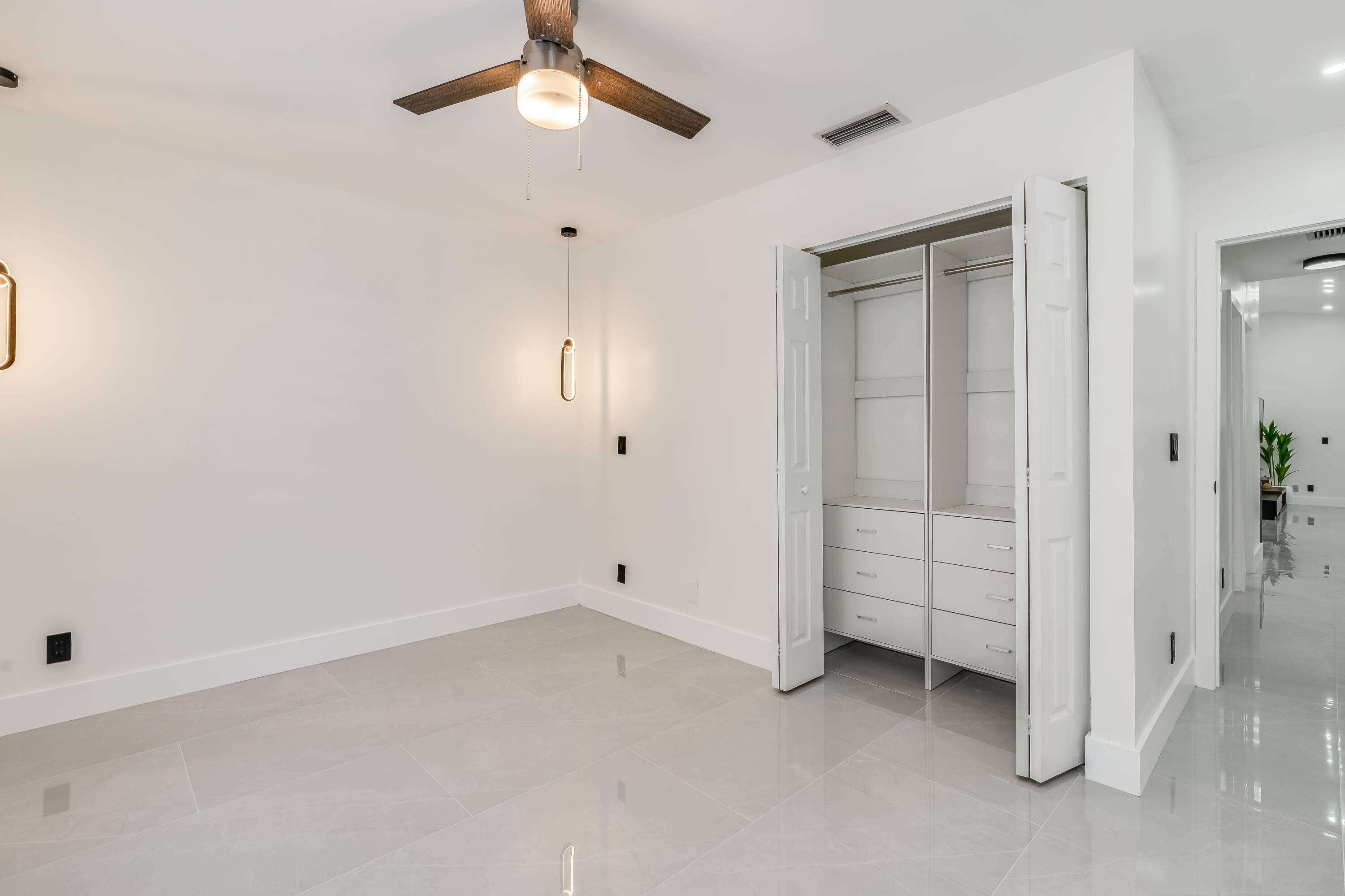 3084 Lighthouse Place Margate, FL 33063 - Photo 20 of 41 an empty room with chandelier fan