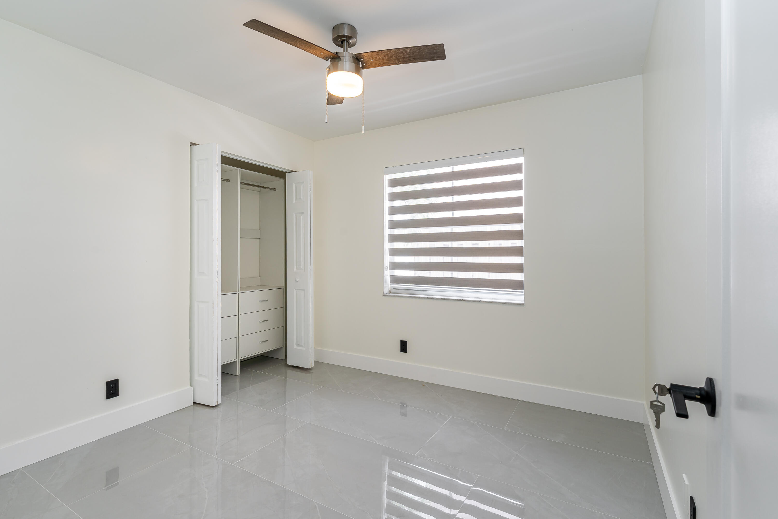3084 Lighthouse Place Margate, FL 33063 - Photo 22 of 41 a view of room with a ceiling fan and window