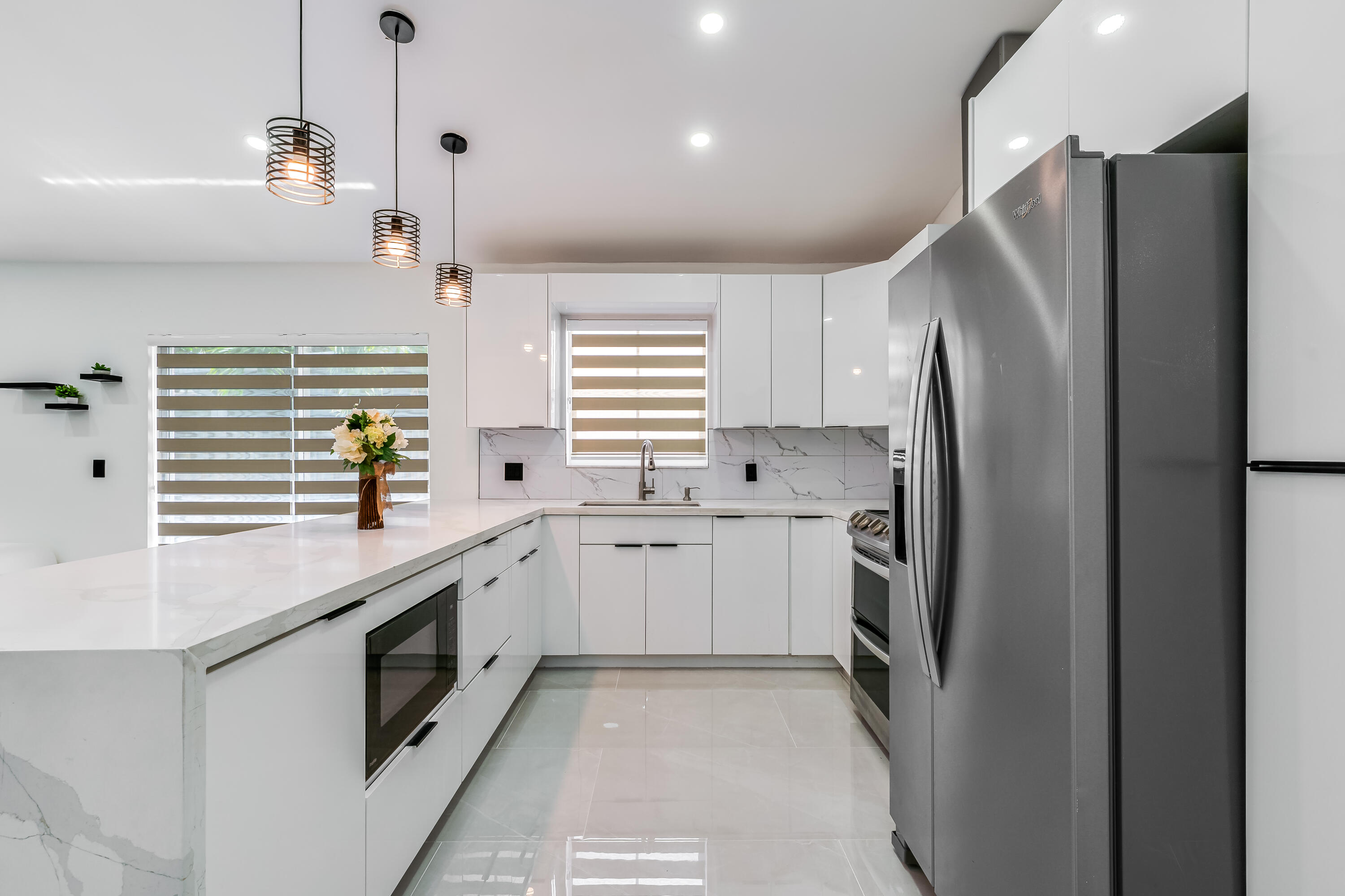 3084 Lighthouse Place Margate, FL 33063 - Photo 9 of 41 a kitchen with stainless steel appliances a refrigerator sink and stove