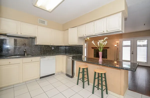 a kitchen with stainless steel appliances granite countertop a sink and cabinets