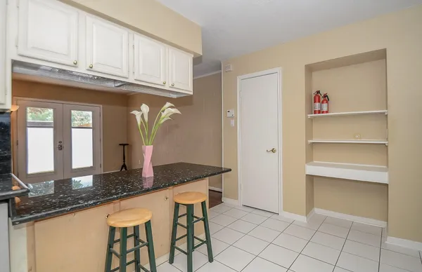 a kitchen with granite countertop a sink and a cabinets