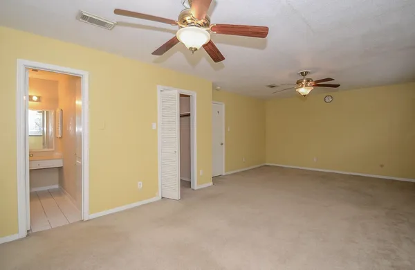 wooden floor in an empty room and a bathroom