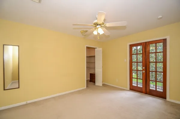 an empty room with windows and closet
