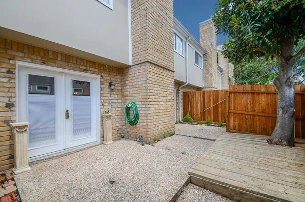 a view of a house with a yard and potted plants