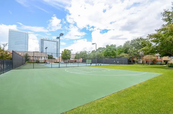 a view of a swimming pool with a patio and a yard