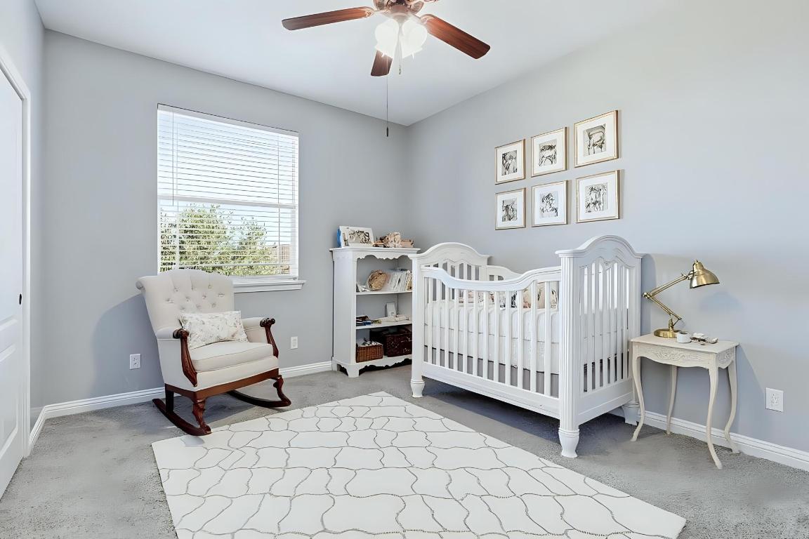 299 Limestone Trail Austin, TX 78737 - Photo 11 of 19 a bedroom with a baby bed a couch and a window