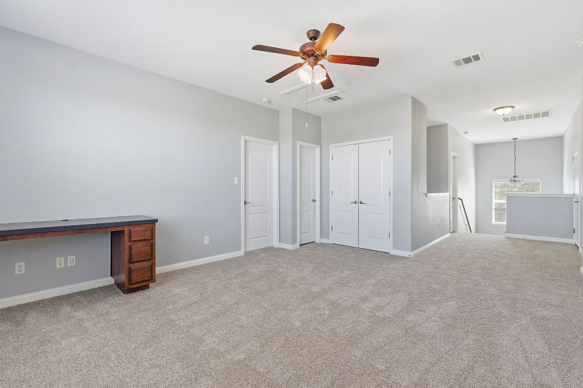 299 Limestone Trail Austin, TX 78737 - Photo 12 of 19 a view of an empty room and a ceiling fan