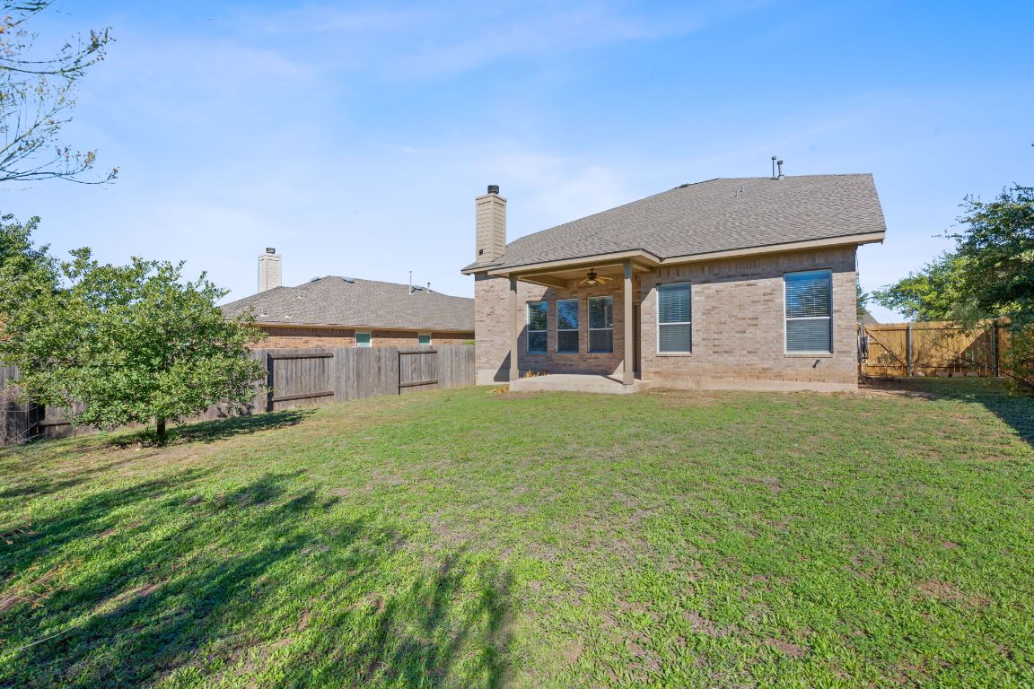 299 Limestone Trail Austin, TX 78737 - Photo 18 of 19 front view of a house with a yard