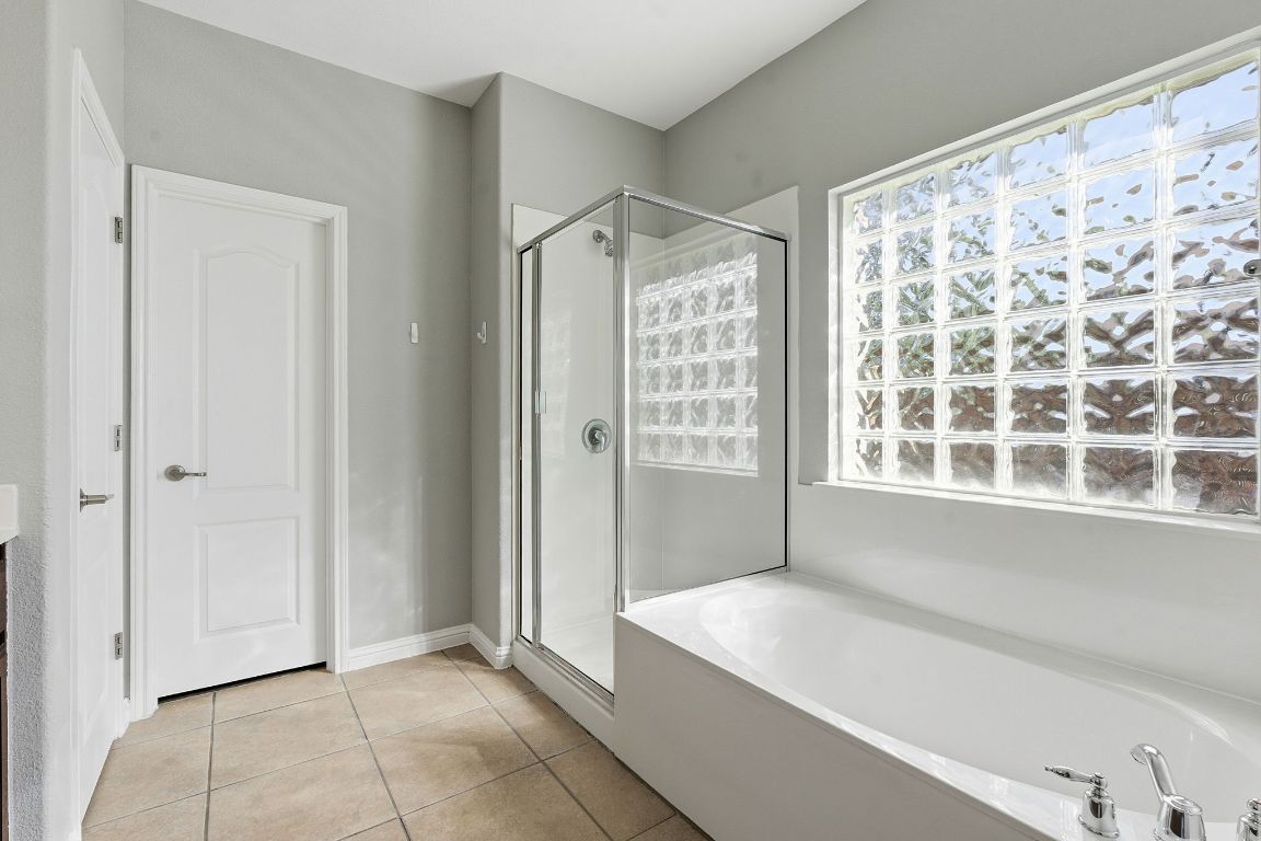 299 Limestone Trail Austin, TX 78737 - Photo 8 of 19 a spacious bathroom with a bathtub and a shower