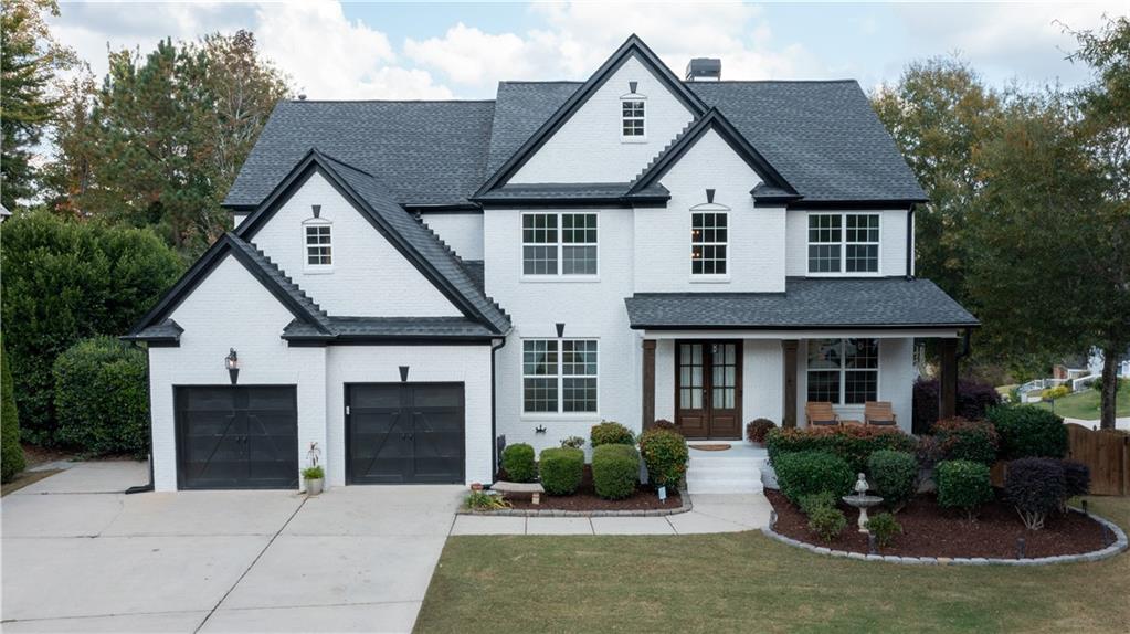 a front view of a house with garden