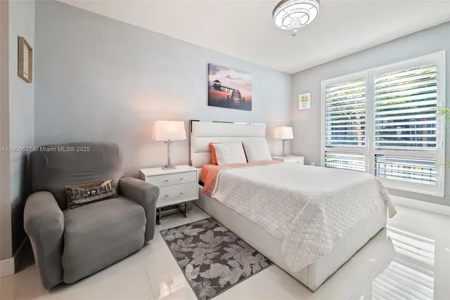 a bedroom with a bed couch and a window