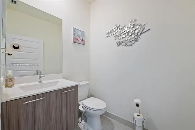a bathroom with a sink mirror and toilet