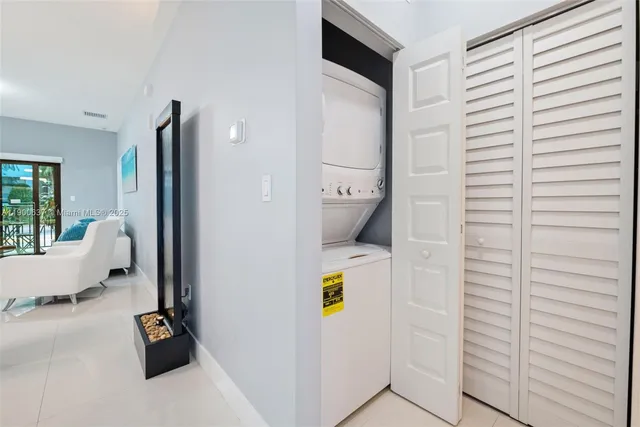 a living room with furniture a large window and a potted plant