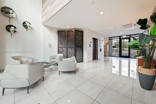 a living room with furniture and a potted plant