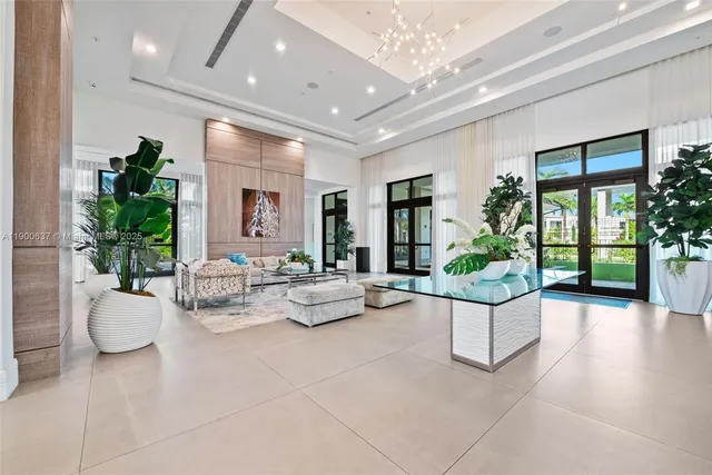 a view of a house with a yard and potted plants