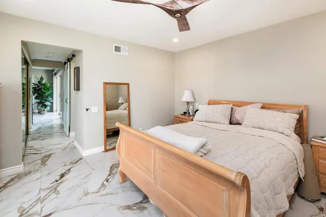 a bedroom with a bed and a mirror