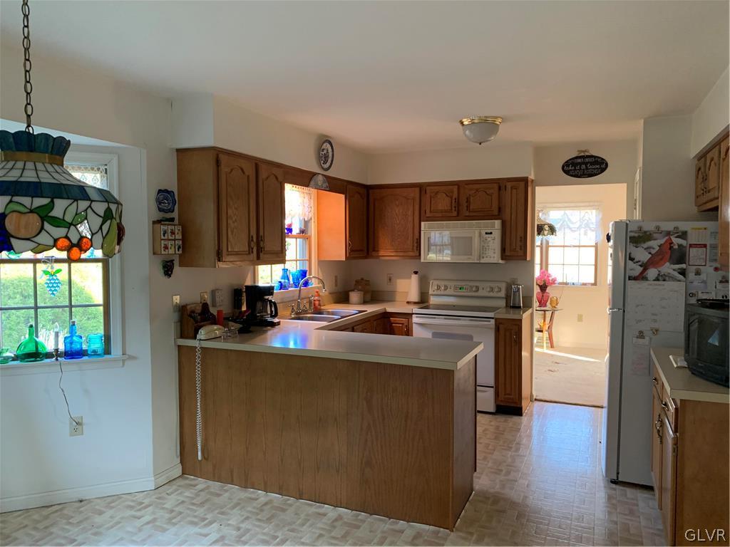 619 Stoney Run Road Pottsville, PA 17901 - Photo 6 of 15 a kitchen with a refrigerator and a stove top oven