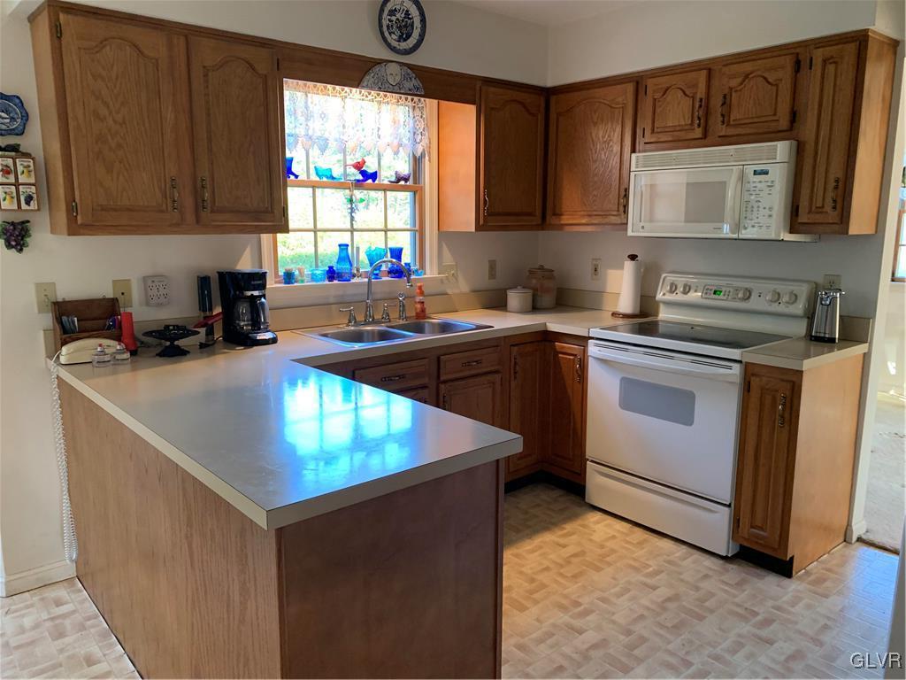 619 Stoney Run Road Pottsville, PA 17901 - Photo 7 of 15 a kitchen with stainless steel appliances granite countertop a sink stove and microwave