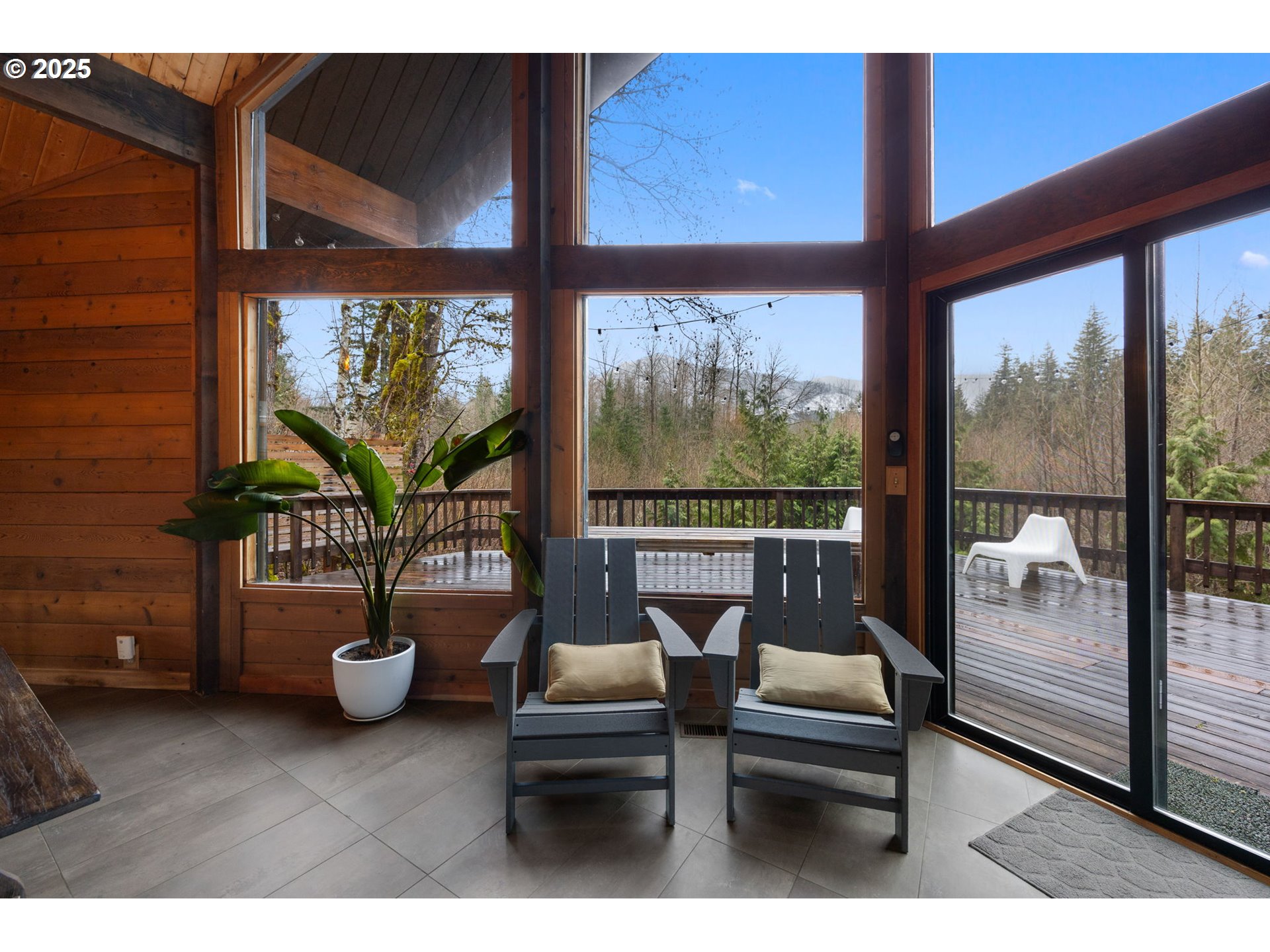 65418 East Sandy River Lane Rhododendron, OR 97049 - Photo 13 of 47 a balcony with furniture and a potted plant