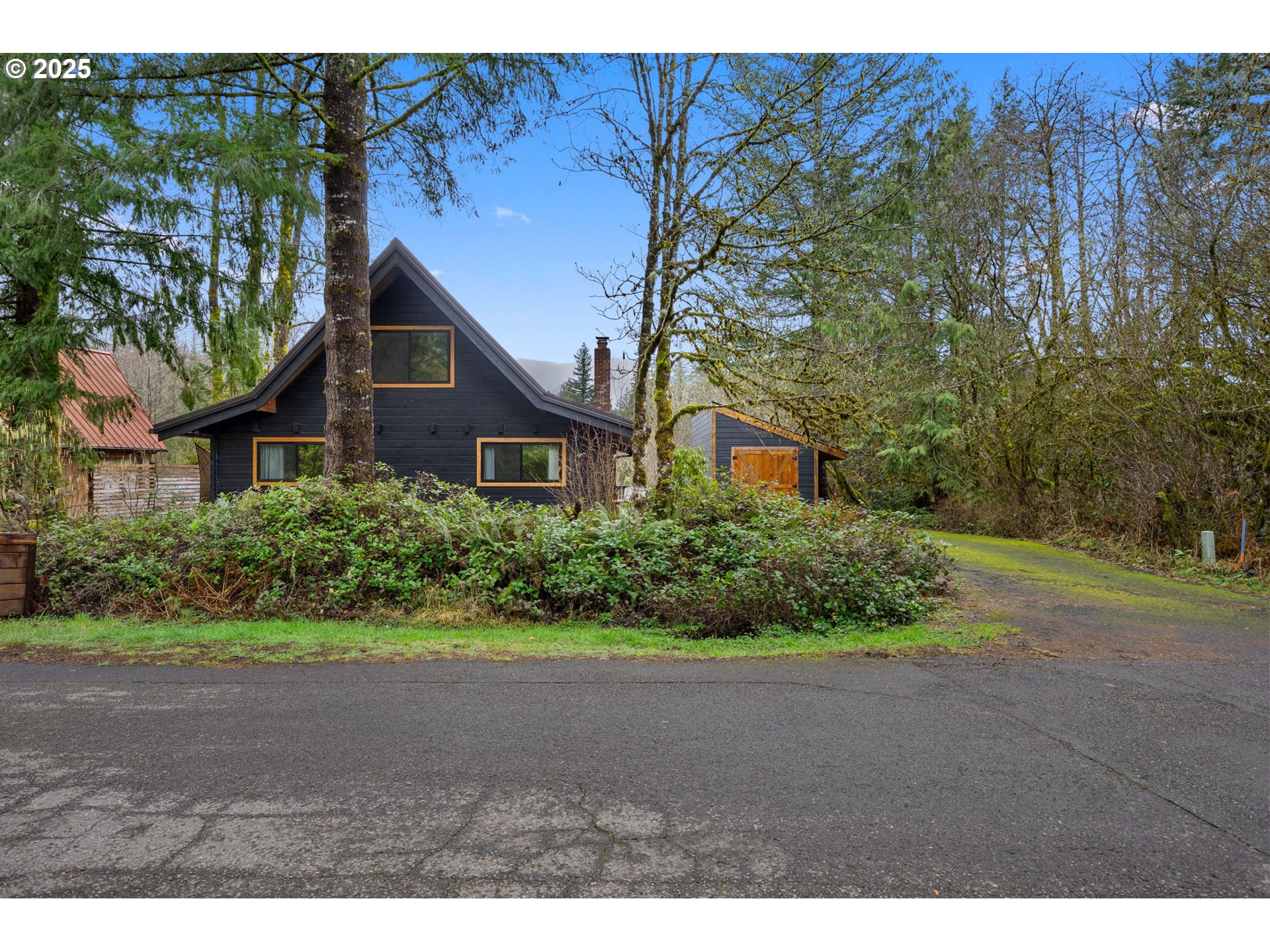 65418 East Sandy River Lane Rhododendron, OR 97049 - Photo 3 of 47 a front view of a house with a yard