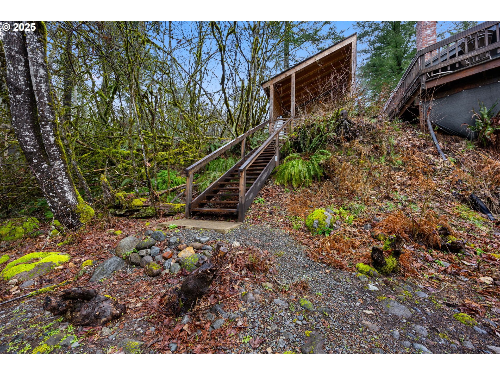 65418 East Sandy River Lane Rhododendron, OR 97049 - Photo 40 of 47 a backyard of a house with lots of green space