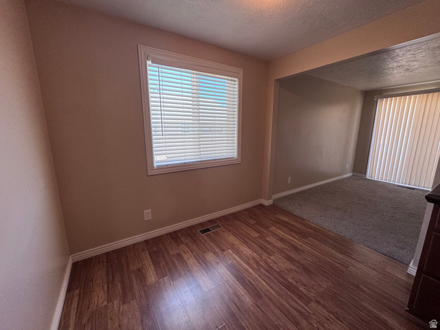 2182 West 5600th Street South Roy, UT 84067 - Photo 2 of 11 Wood-finish flooring in a neutral-toned room with a window featuring white blinds