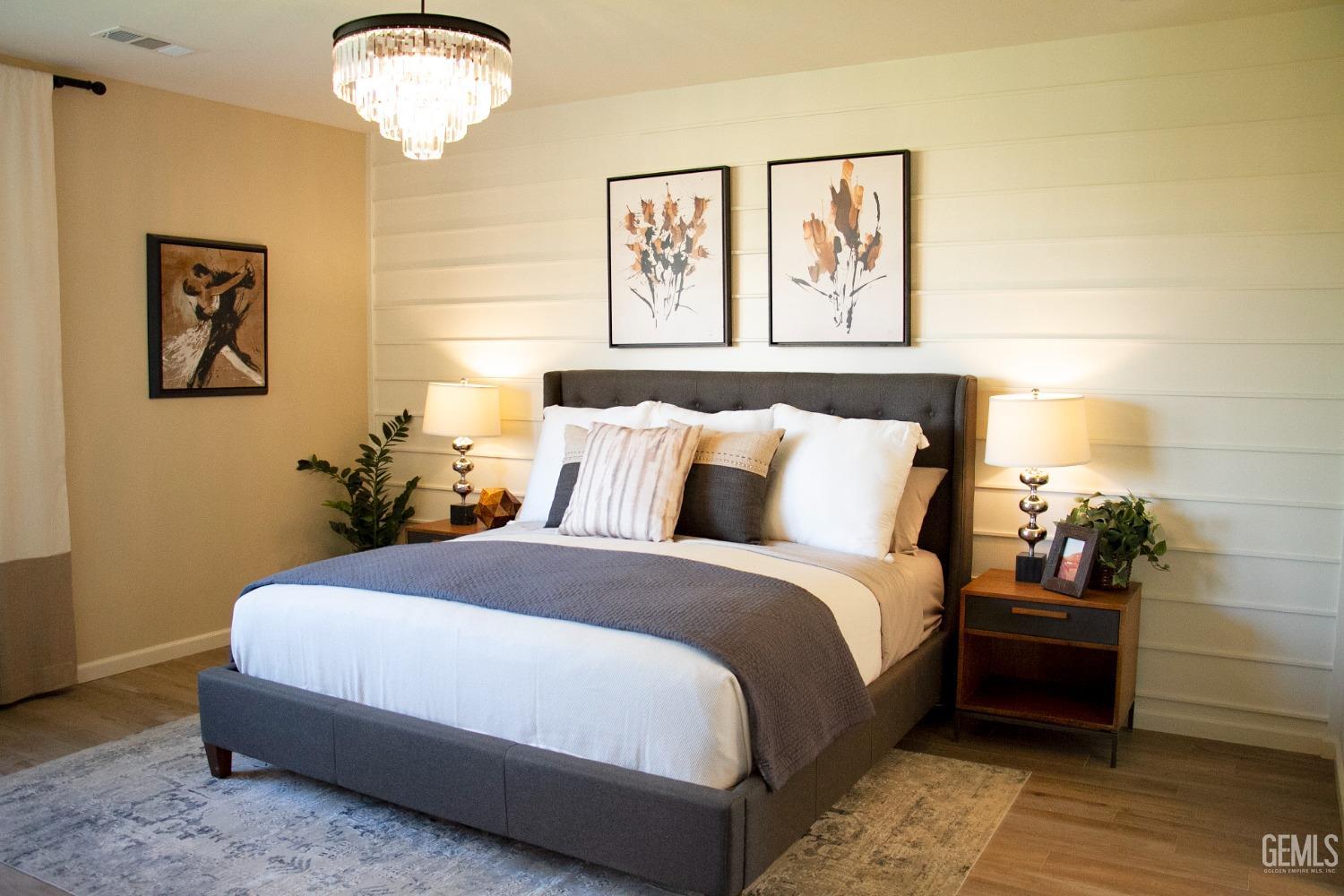 Undisclosed Address Delano, CA 93215 - Photo 3 of 7 a bedroom with a bed and a chandelier