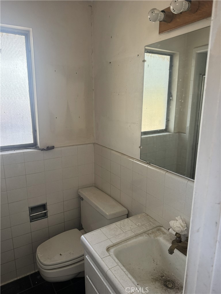17545 Community Street Northridge, CA 91325 - Photo 12 of 22 a bathroom with a sink a toilet and a mirror