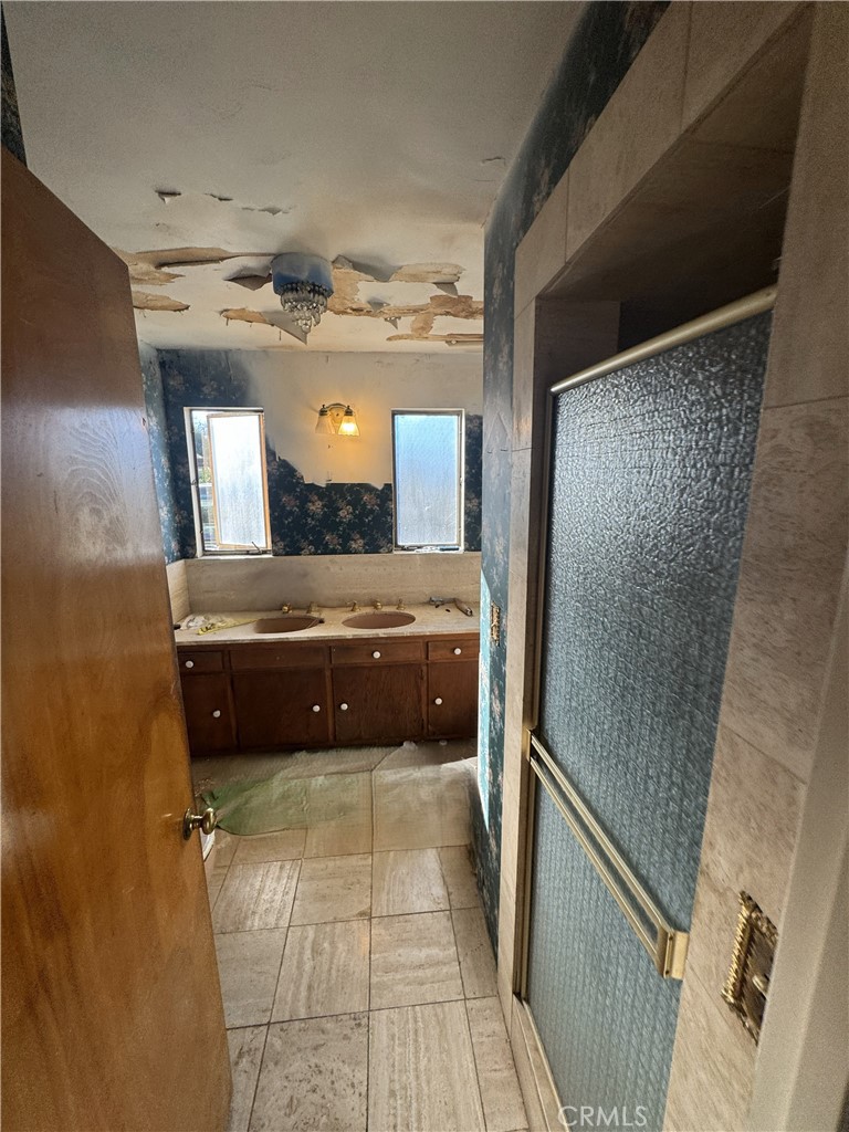 17545 Community Street Northridge, CA 91325 - Photo 13 of 22 a bathroom with a double vanity and a mirror