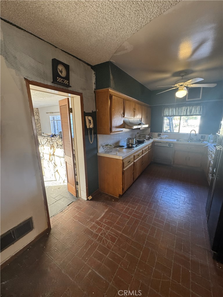 17545 Community Street Northridge, CA 91325 - Photo 8 of 22 a kitchen with stainless steel appliances granite countertop a sink and a stove top oven
