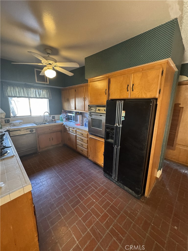 17545 Community Street Northridge, CA 91325 - Photo 9 of 22 a kitchen with cabinets and stainless steel appliances