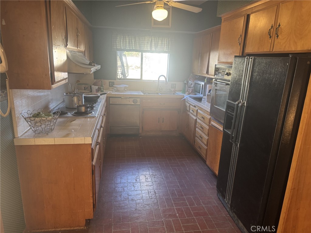 17545 Community Street Northridge, CA 91325 - Photo 10 of 22 a kitchen with a refrigerator sink washer and dryer