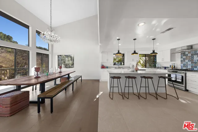 a dining room with furniture a chandelier and wooden floor
