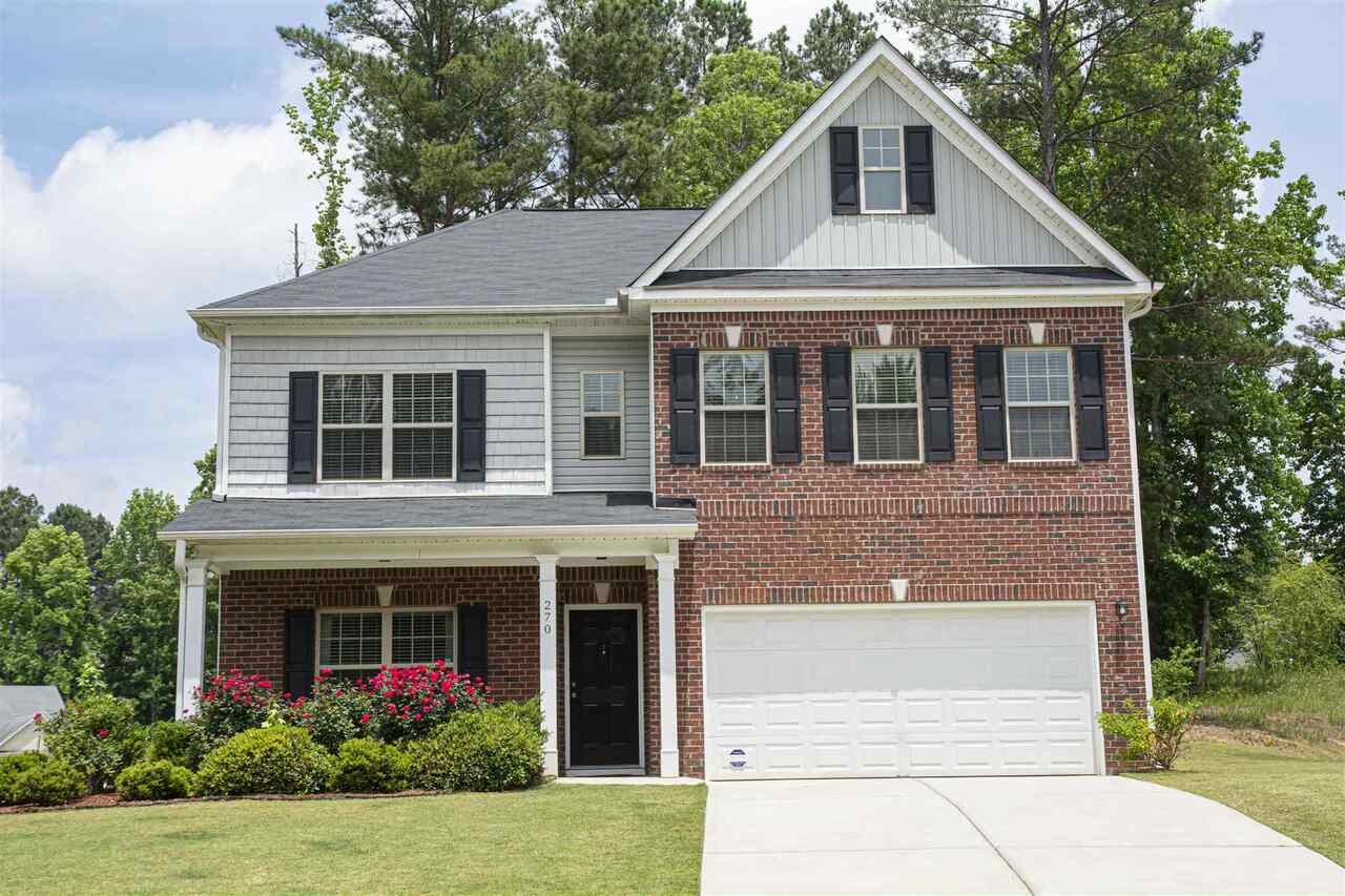 270 Windpher Ridge Hampton, GA 30228 - Photo 1 of 1 a front view of a house with garden
