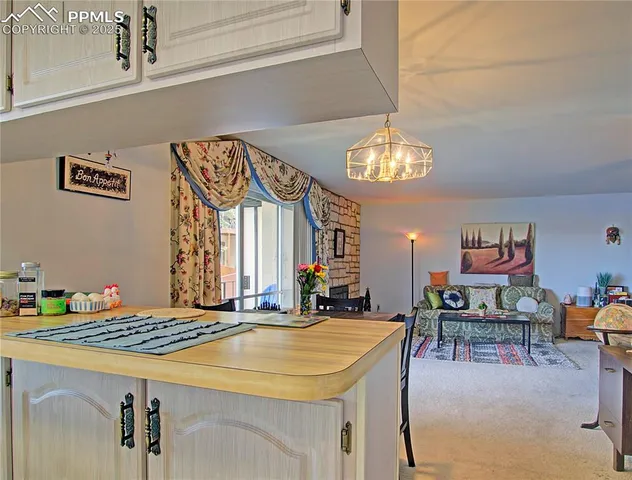 a view of a dining room with furniture and chandelier