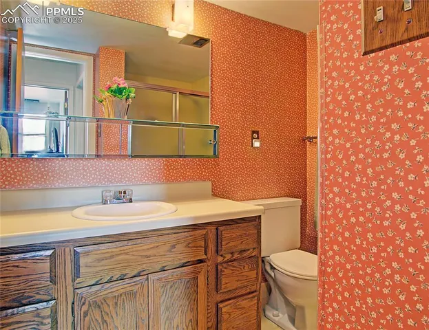 a bathroom with a sink a toilet and mirror