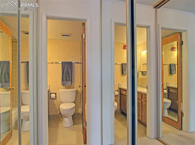 a bathroom with a granite countertop shower and a toilet