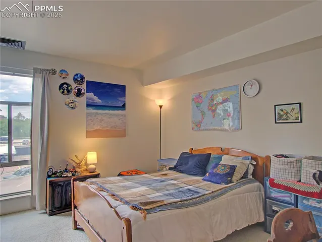 a bed room with a bed and a desk