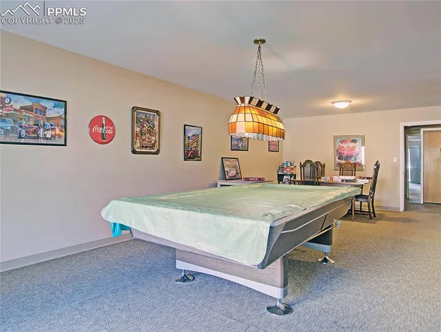 a room with pool table and windows