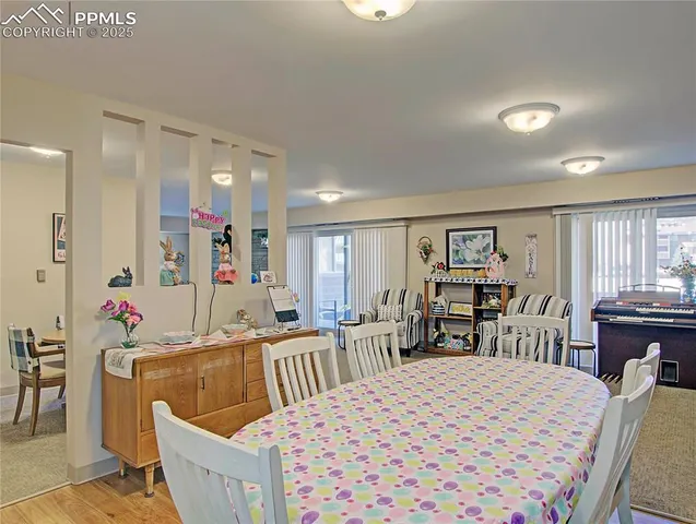 a bed room with a bed a table and chairs in it