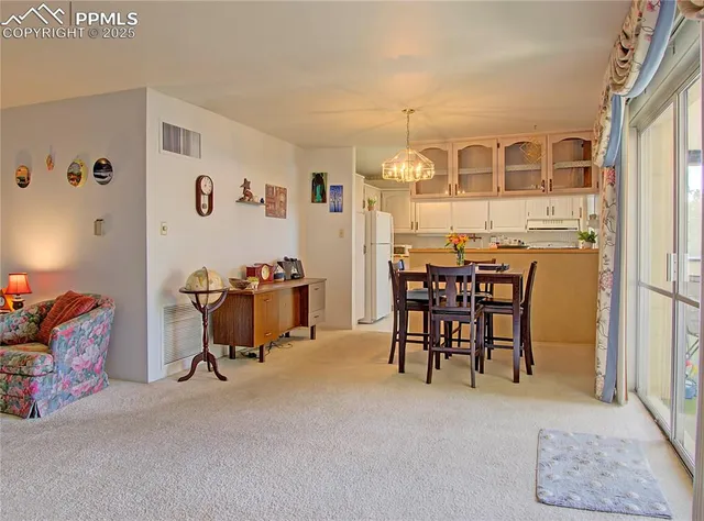 a view of a livingroom with furniture and a window