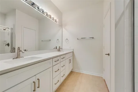 a bathroom with a glass shower door